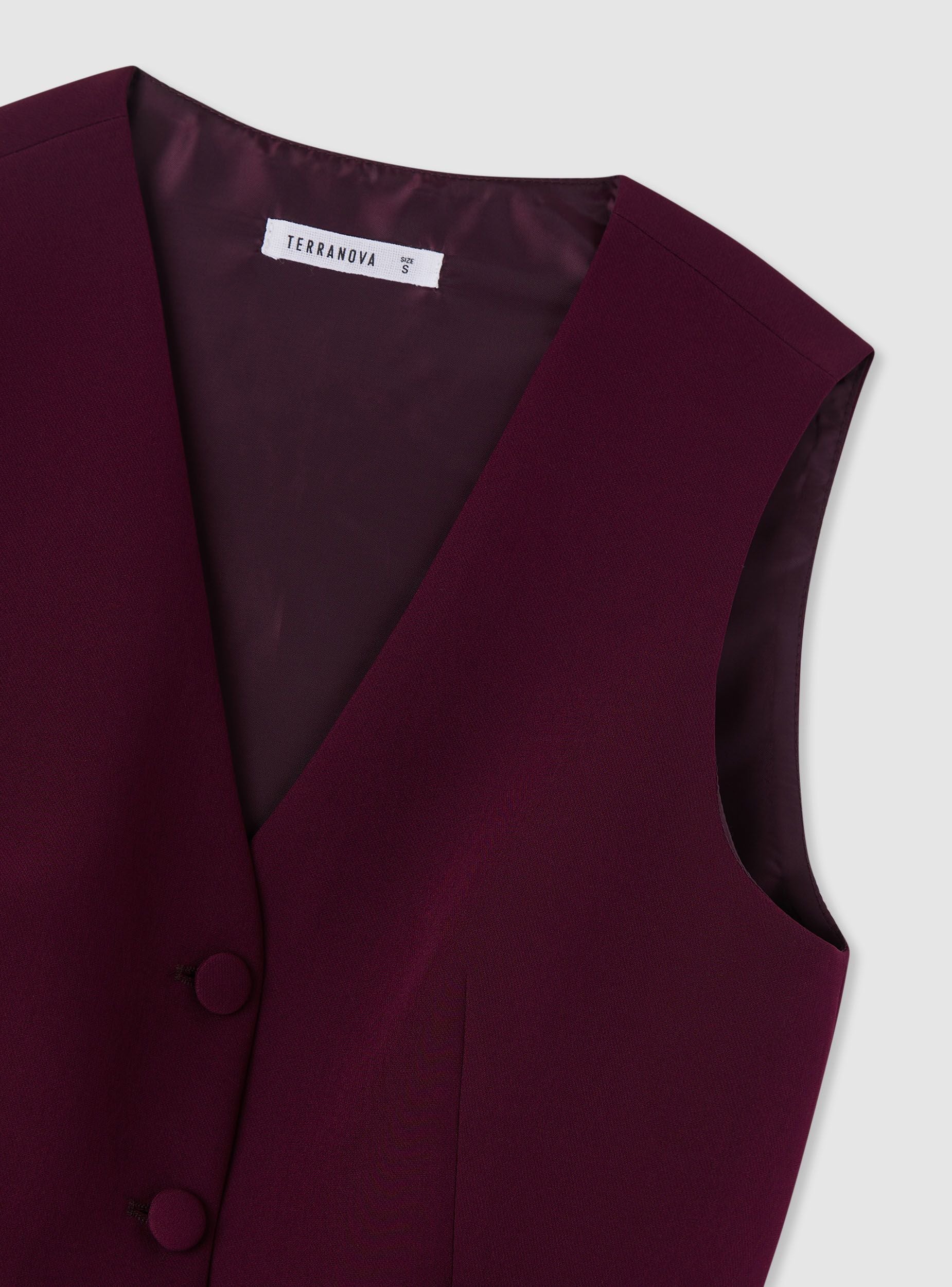 Gilet tinta unita con bottoni